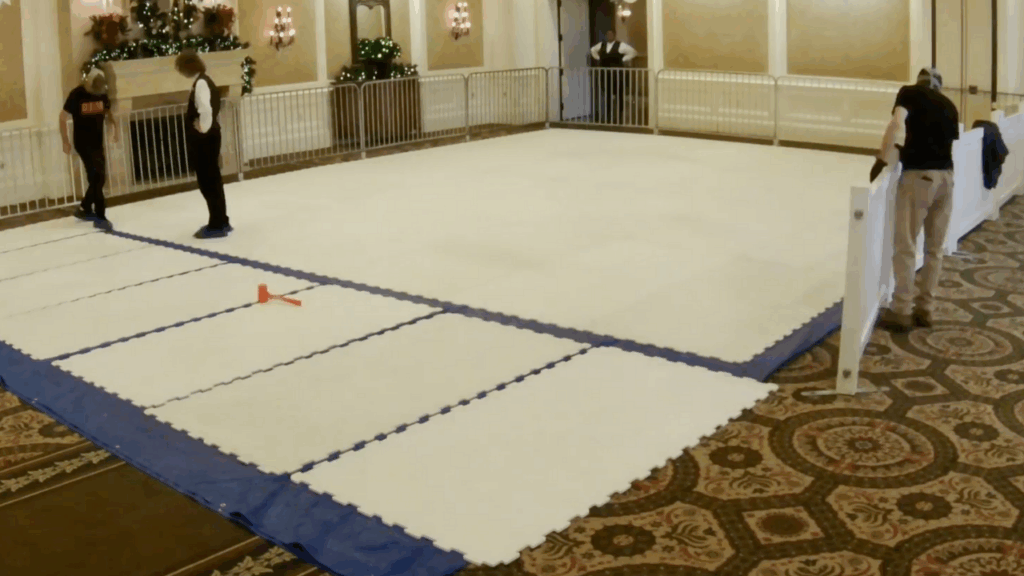 People assembling synthetic iceless ice skating rink