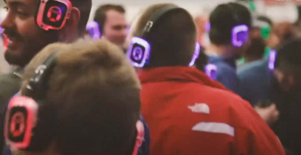 People where headphones with different colored LED lights during a silent disco
